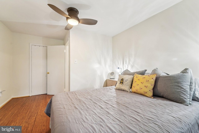 bedroom featuring baseboards, ceiling fan, and wood finished floors