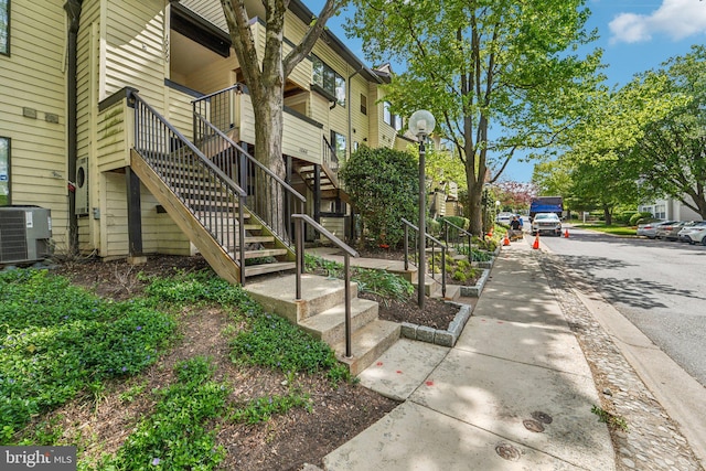 exterior space with cooling unit and stairs