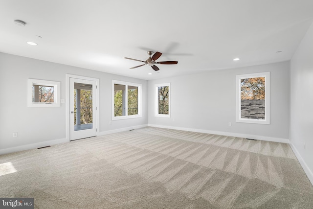 carpeted empty room featuring recessed lighting, visible vents, baseboards, and ceiling fan
