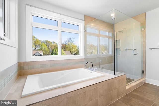 bathroom with a shower stall and a garden tub