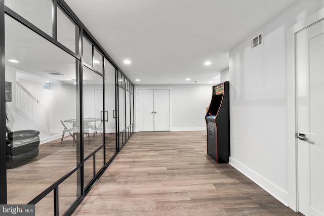 corridor with light wood-style flooring, visible vents, stairway, recessed lighting, and baseboards