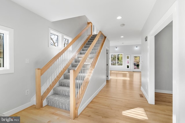stairs featuring recessed lighting, visible vents, baseboards, and wood finished floors