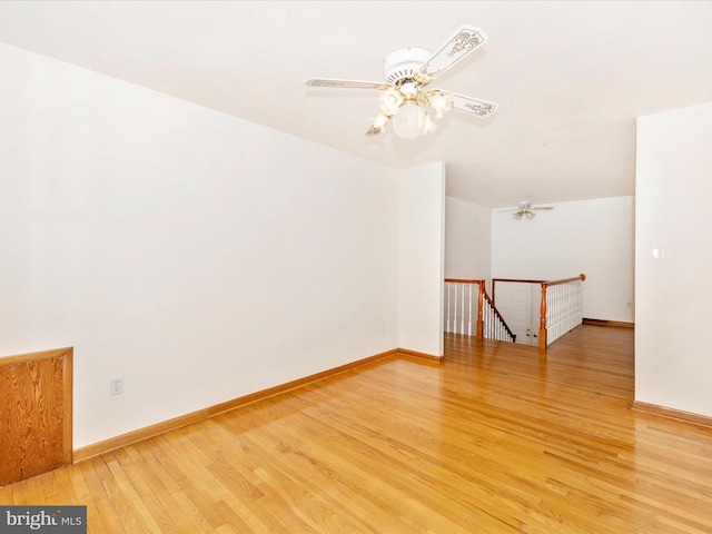 bonus room with a ceiling fan, baseboards, and light wood finished floors