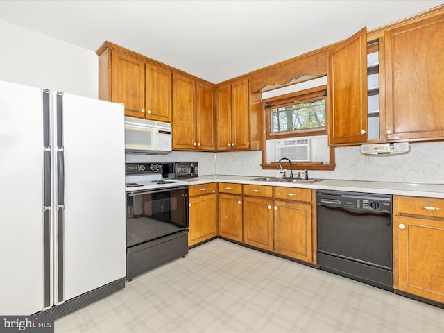 kitchen with a sink, white appliances, light countertops, light floors, and backsplash