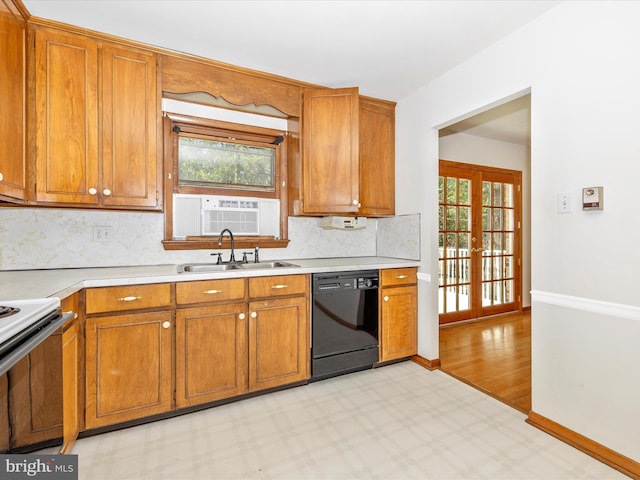 kitchen with white range with electric cooktop, black dishwasher, light countertops, brown cabinets, and french doors