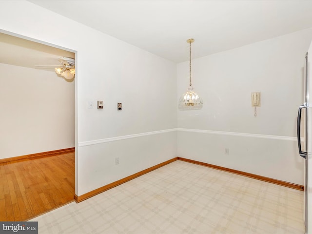 unfurnished room with baseboards and light wood-style flooring