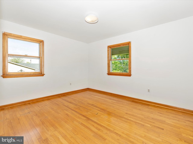 empty room featuring light wood-style floors and baseboards