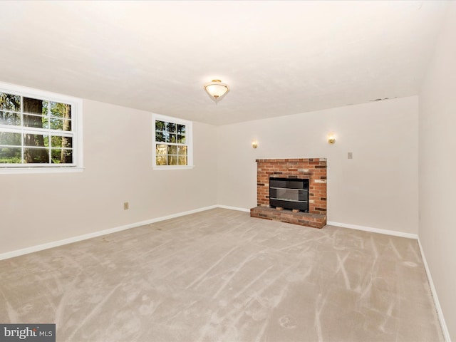 unfurnished living room featuring baseboards, plenty of natural light, and light carpet