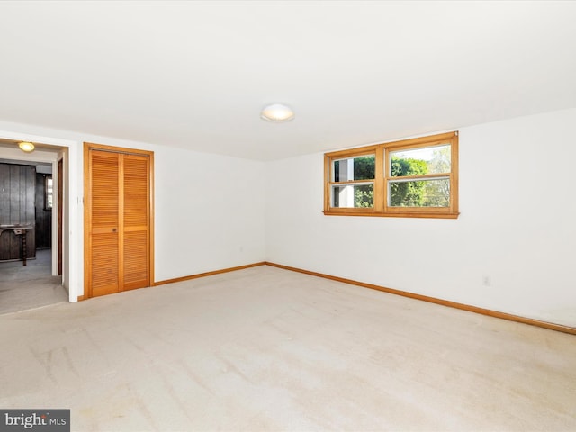 interior space with carpet floors, baseboards, and a closet