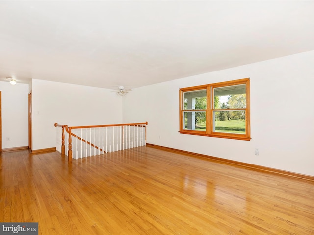 bonus room featuring baseboards and light wood-style floors