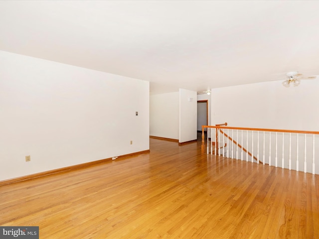 empty room with light wood-style floors and baseboards