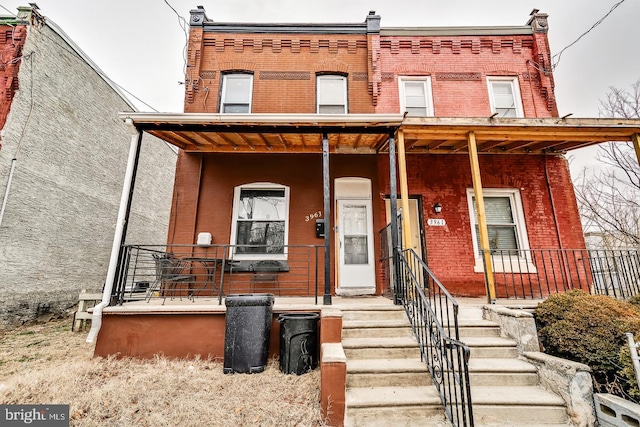3963 Brown St, Philadelphia, PA 19104 - view of property featuring brick siding and covered porch