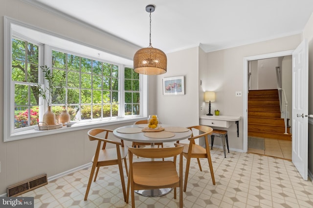dining space featuring crown molding, light floors, stairs, and visible vents