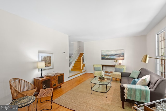 living room featuring stairs and wood finished floors
