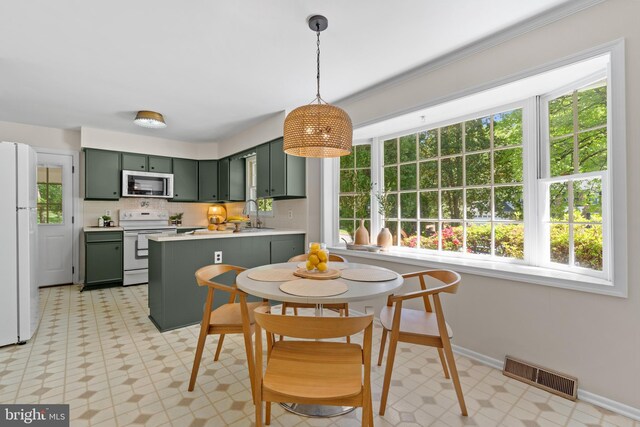 dining space featuring visible vents, plenty of natural light, and light floors