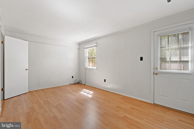 empty room with light wood-style floors and baseboards