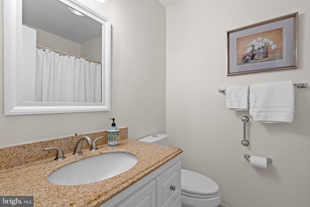 bathroom featuring vanity and toilet