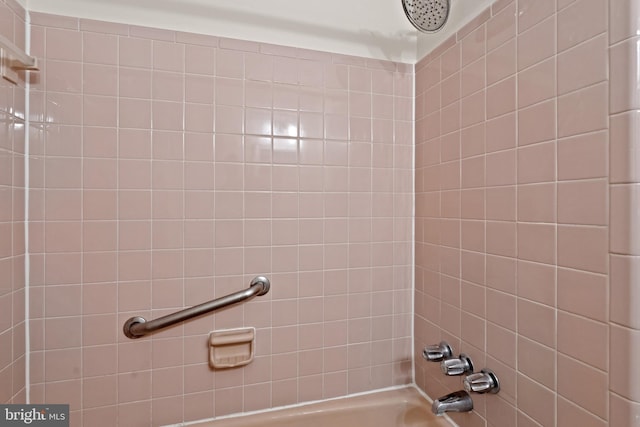 full bath with a combined bath / shower with rainfall shower