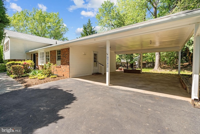 view of parking / parking lot with a carport and driveway