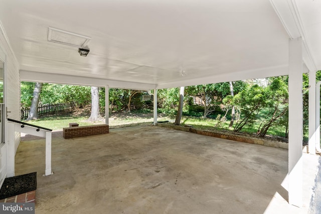 view of patio / terrace featuring fence and a carport
