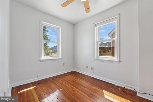 unfurnished room featuring baseboards, ceiling fan, and hardwood / wood-style floors