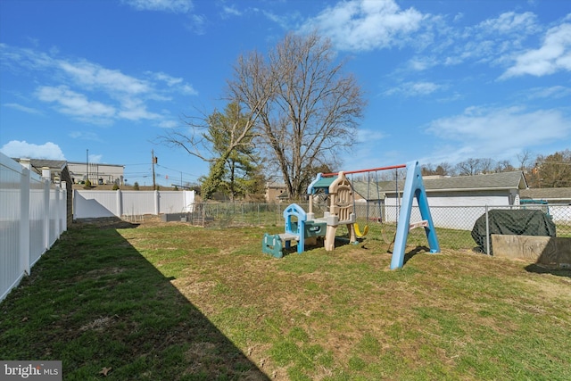view of yard with a fenced backyard and a playground