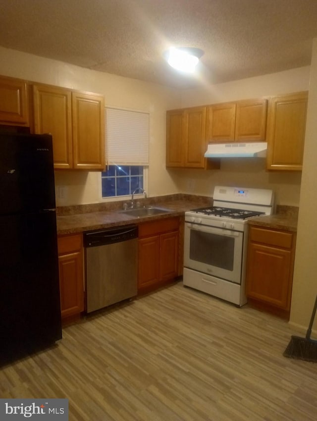 100 Park Blvd Unit 17D, Cherry Hill, NJ 08034 - kitchen featuring freestanding refrigerator, dishwasher, white range with gas stovetop, under cabinet range hood, and a sink
