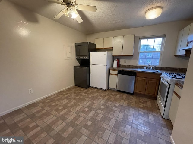 100 Park Blvd Unit 17D, Cherry Hill, NJ 08034 - kitchen featuring white appliances, a sink, dark countertops, brick patterned flooring, and baseboards