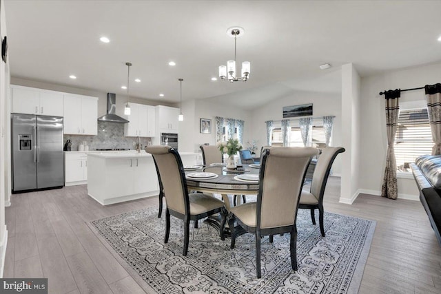 dining space featuring light wood-style floors, baseboards, recessed lighting, a chandelier, and vaulted ceiling