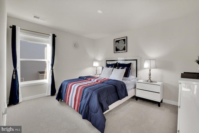carpeted bedroom featuring baseboards and visible vents