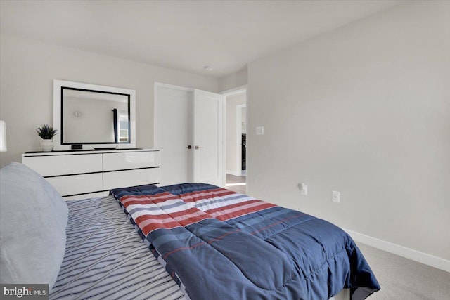 carpeted bedroom featuring baseboards