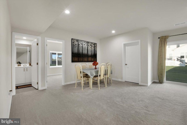 carpeted dining room with visible vents, recessed lighting, baseboards, and a healthy amount of sunlight