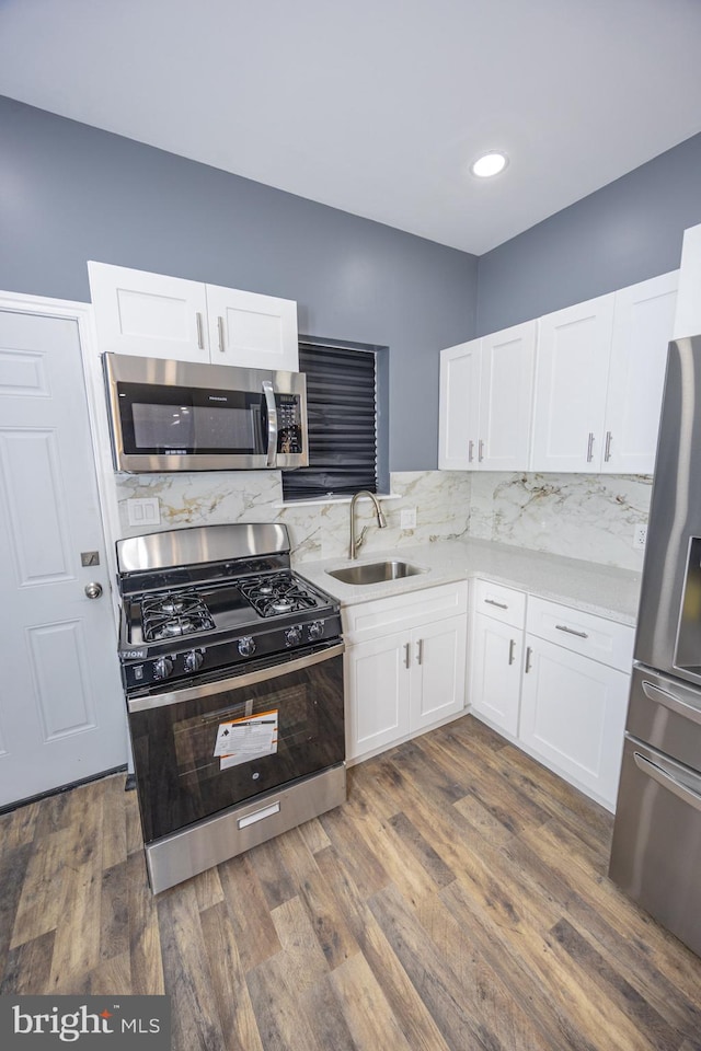 173 W Seymour St, Philadelphia, PA 19144 - kitchen with white cabinetry, a sink, dark wood finished floors, and stainless steel appliances