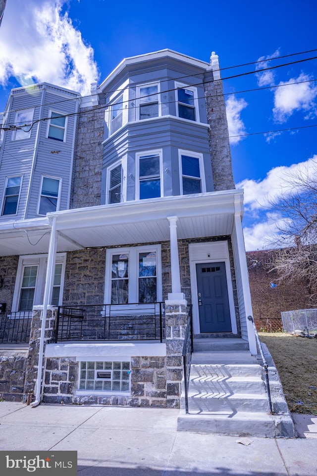 173 W Seymour St, Philadelphia, PA 19144 - townhome / multi-family property featuring a porch and stone siding