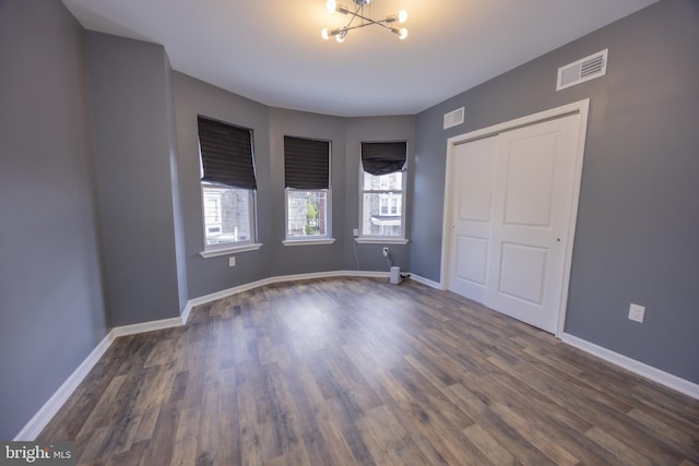 173 W Seymour St, Philadelphia, PA 19144 - unfurnished bedroom with dark wood-type flooring, visible vents, baseboards, and a notable chandelier