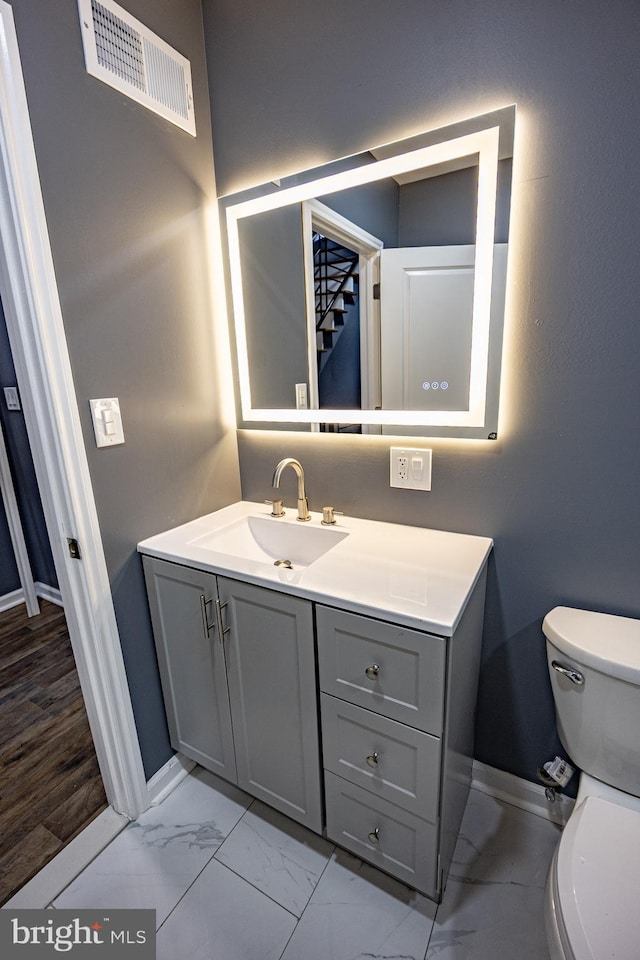 173 W Seymour St, Philadelphia, PA 19144 - bathroom with vanity, baseboards, toilet, visible vents, and marble finish floor