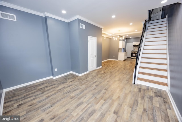 173 W Seymour St, Philadelphia, PA 19144 - unfurnished living room featuring crown molding, an inviting chandelier, visible vents, stairs, and light wood finished floors
