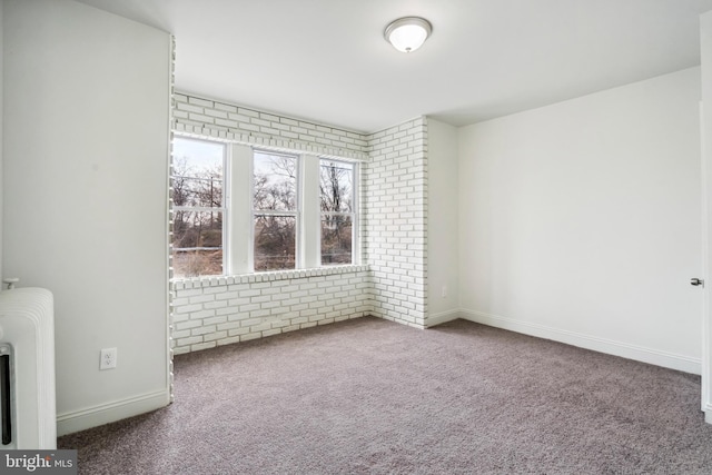 4914 N Smedley St, Philadelphia, PA 19141 - carpeted empty room featuring radiator heating unit, brick wall, and baseboards