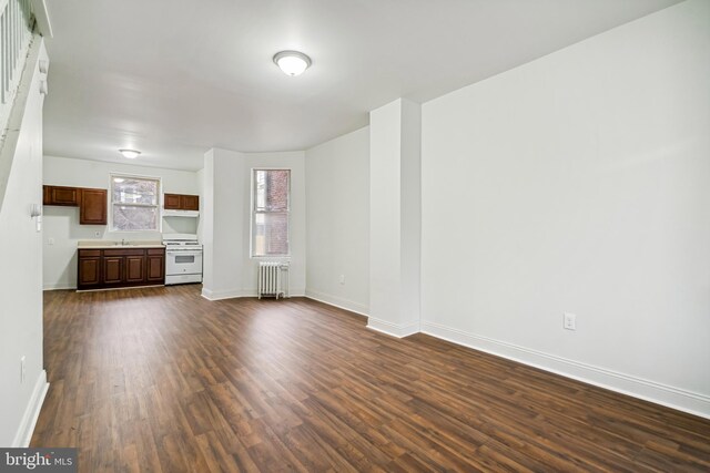 4914 N Smedley St, Philadelphia, PA 19141 - unfurnished living room with radiator, a sink, baseboards, and dark wood finished floors