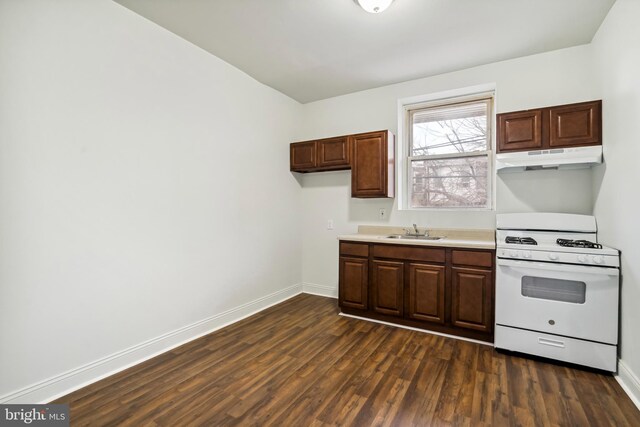 4914 N Smedley St, Philadelphia, PA 19141 - kitchen with a sink, light countertops, gas range gas stove, dark wood finished floors, and under cabinet range hood