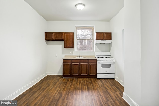 4914 N Smedley St, Philadelphia, PA 19141 - kitchen featuring baseboards, dark wood-style flooring, light countertops, under cabinet range hood, and white gas range