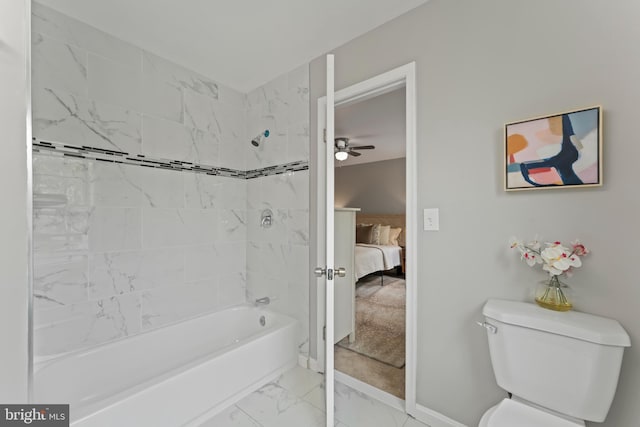 ensuite bathroom with toilet, ceiling fan, shower / bathing tub combination, connected bathroom, and marble finish floor