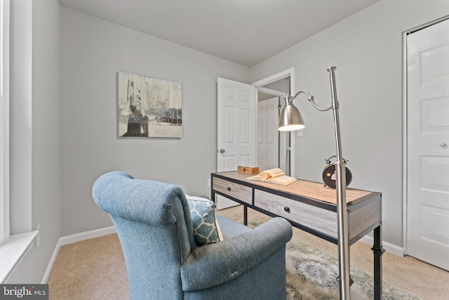 home office with baseboards and light carpet