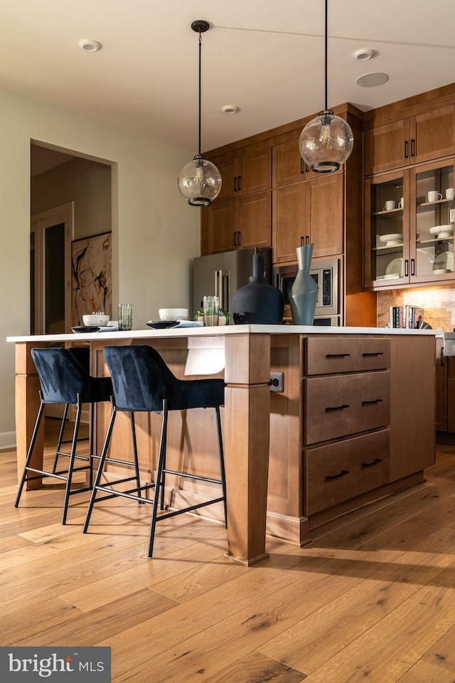kitchen featuring light wood-style flooring, appliances with stainless steel finishes, and light countertops