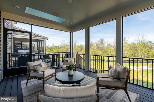 sunroom with a skylight and an outdoor hangout area