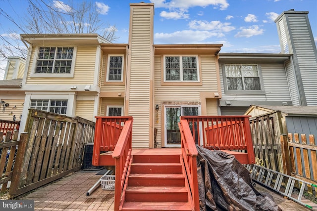 3 Casino Ct, Silver Spring, MD 20906 - rear view of house featuring fence, a wooden deck, and a chimney