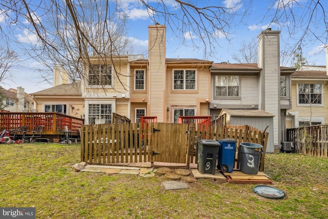 3 Casino Ct, Silver Spring, MD 20906 - back of property featuring a chimney, a wooden deck, fence, and a lawn
