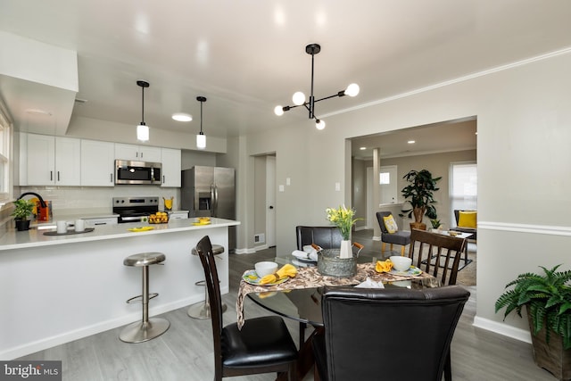 dining space with visible vents, baseboards, ornamental molding, and wood finished floors