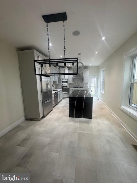 1809 Christian St, Philadelphia, PA 19146 - kitchen with baseboards, a kitchen island, and stainless steel appliances