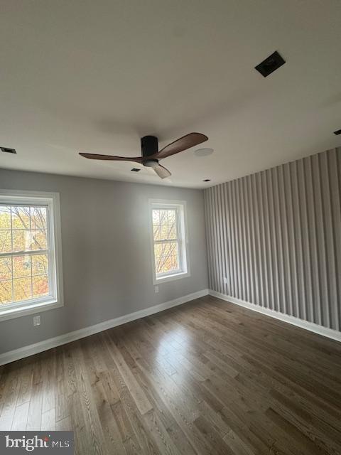 1809 Christian St, Philadelphia, PA 19146 - unfurnished room with baseboards, ceiling fan, wood finished floors, and visible vents